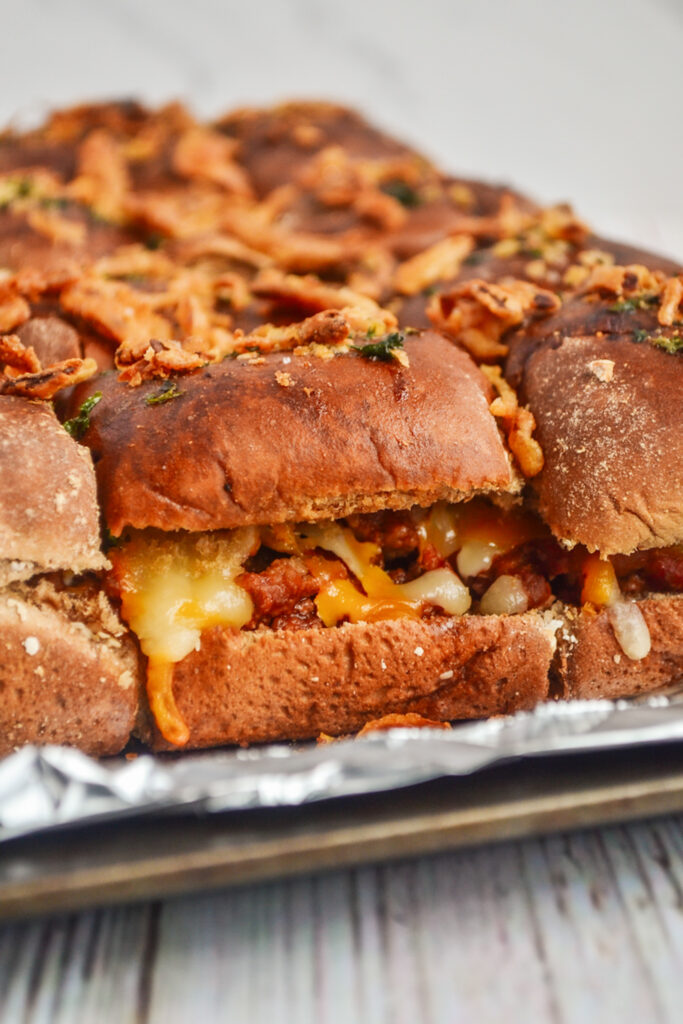 side view of sloppy Joe sliders with Manwich on a foil-rimmed pan