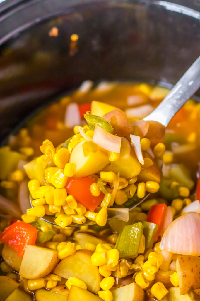 spoonful of potatoes and vegetables in slow cooker