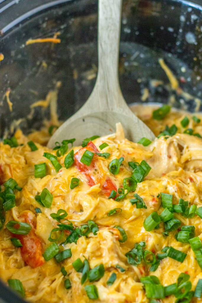Crockpot sweet chili chicken with wooden spoon