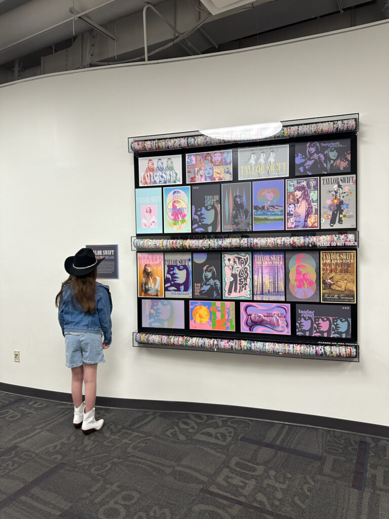 little girl looking at Taylor Swift display at Country Music Hall of Fame Museum as part of a family Nashville itinerary