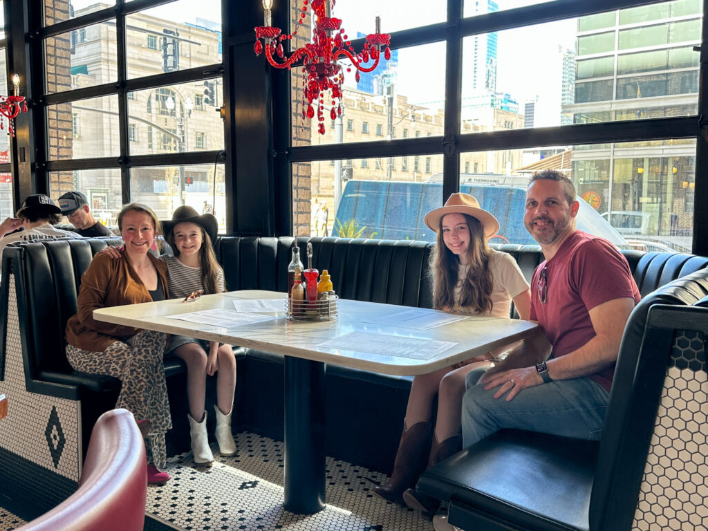 family sitting at booth at The Diner in  Nashville, Tennessee itinerary with kids
