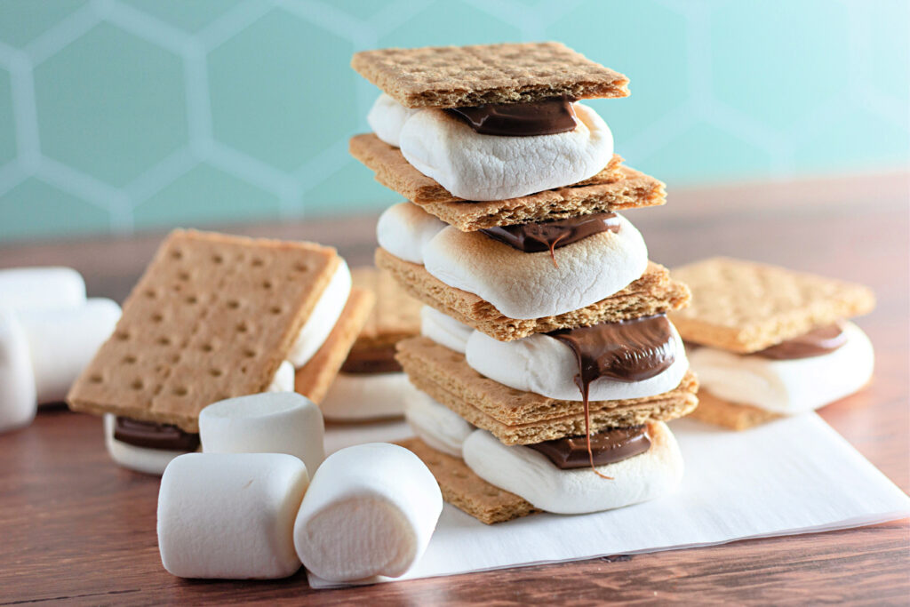oven baked s'mores stacked on parchment paper