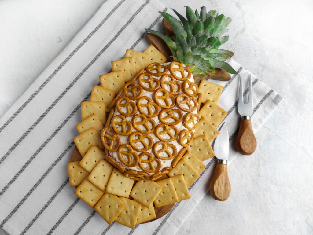 pineapple bacon cheese ball on striped napkin