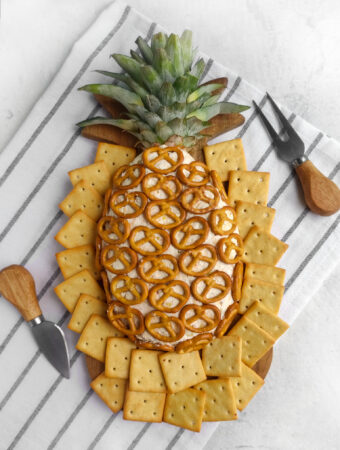 bacon cheddare pineapple cheese ball on striped background