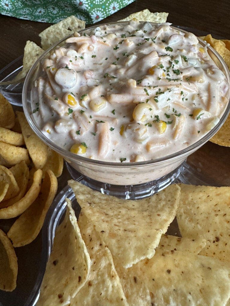 chilled Mexicorn dip with Rotel on serving platter with Fritos and tortilla chips