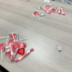 single die on table with candy