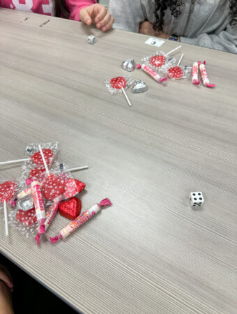 single die on table with candy