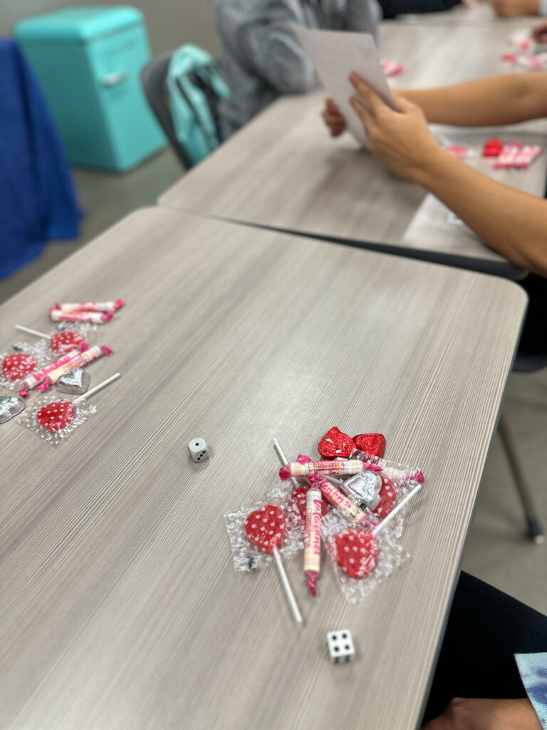 classroom game with dice and candy on table to be used with online single die generator