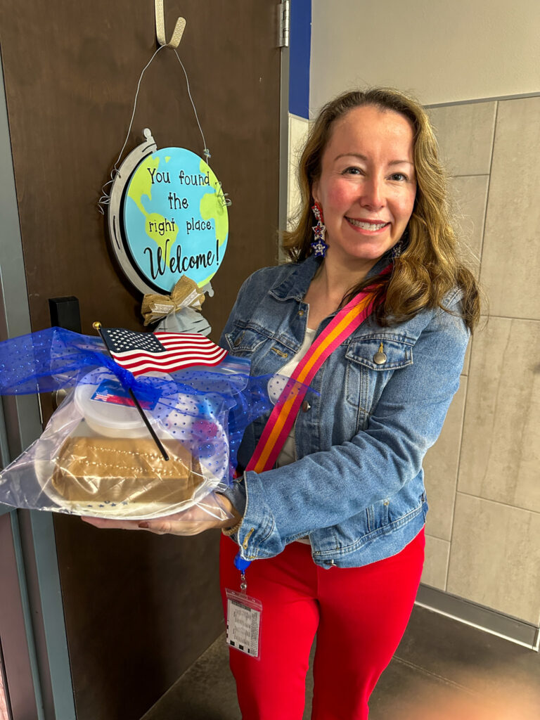 teacher holds Veteran's Day gift in hand for staff veterans