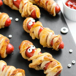 Halloween mummies in a blanket on black tray