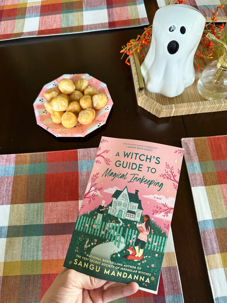 witchy book and donut holes on table for a BOOks and BOOs party for sassy Halloween party themes