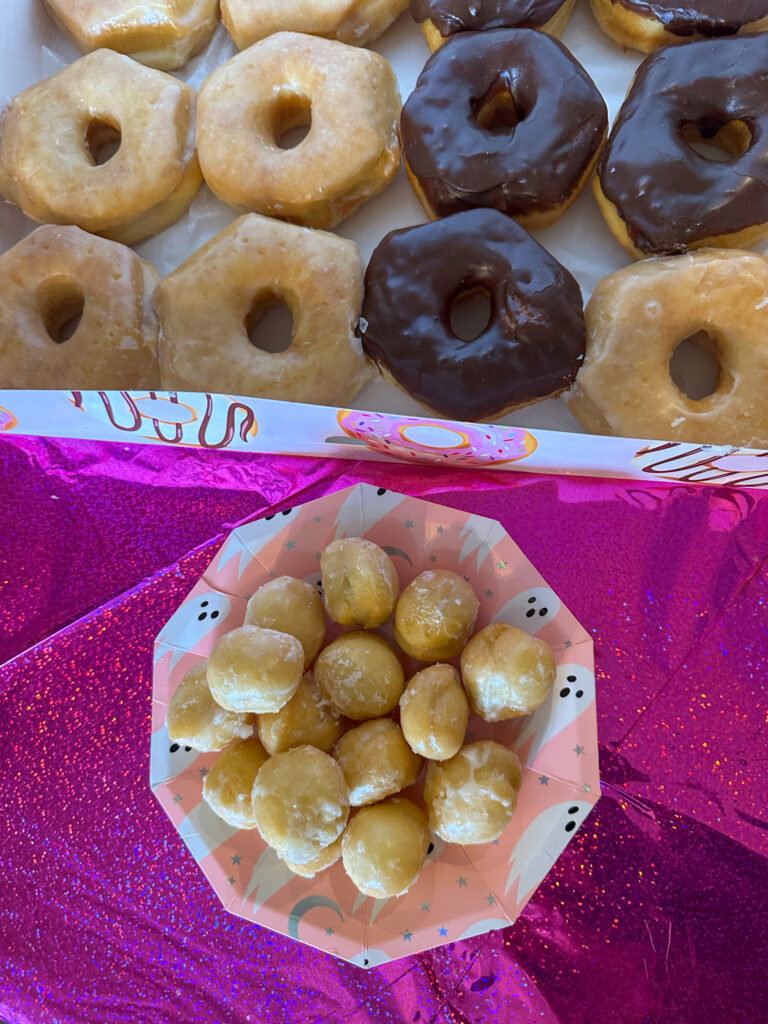 donut holes on ghost plate by box of donuts for a morning brunch Halloween party with a Boo-uenos Dias theme