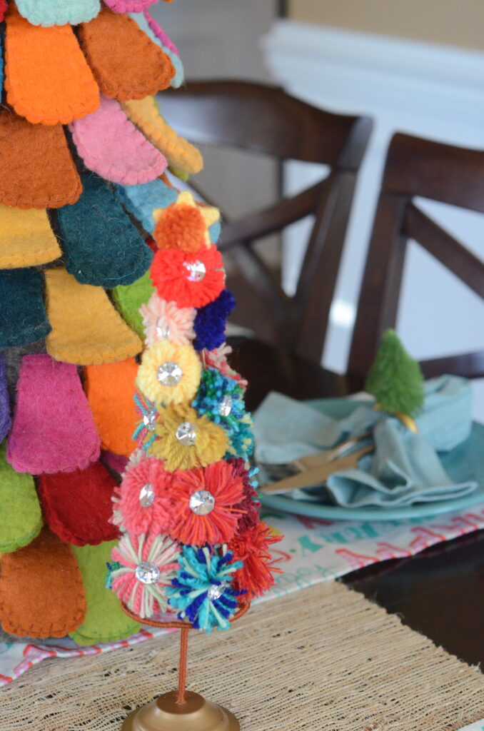 fab-yule-ous fiesta Christmas decorations on dining table - pom pom trees