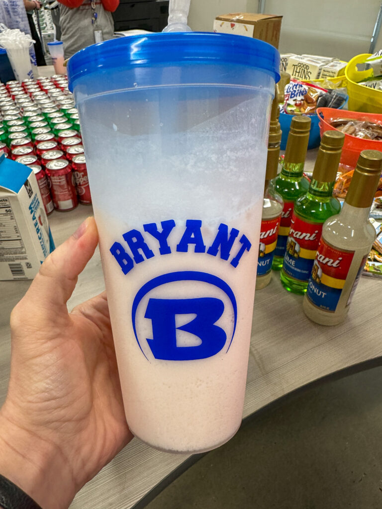 woman holds dirty soda in hand in school cup at a Teacher Appreciation Dirty Soda Bar