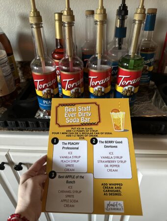 woman holds free dirty soda bar for staff appreciation