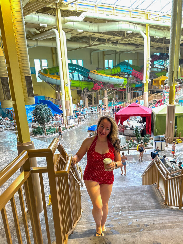 woman climbs stairs in the indoor waterpark at Okana Resort in OKC